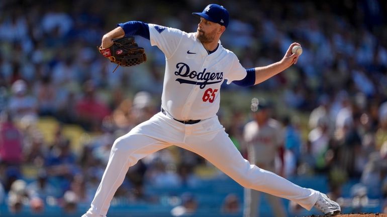 Los Angeles Dodgers starting pitcher James Paxton throws during the...