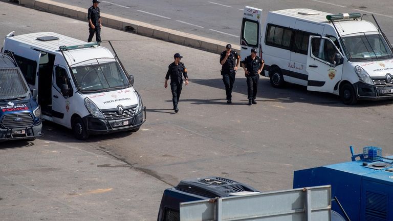 Moroccan security forces stand guard outside the border with the...