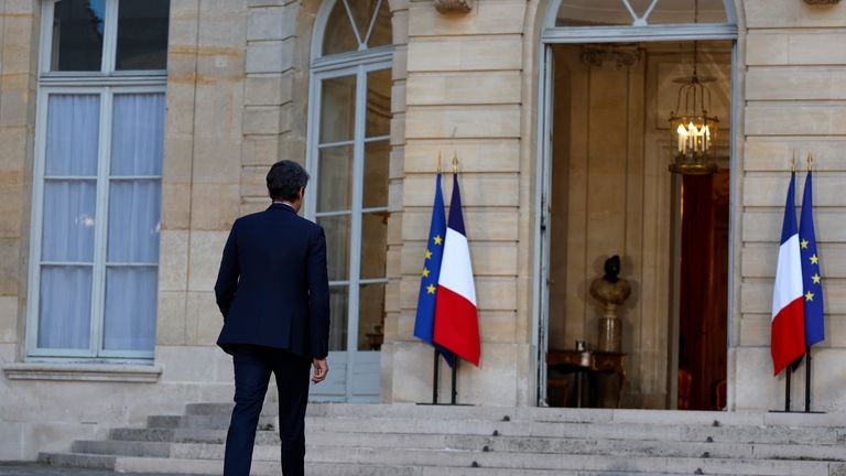 French Prime Minister Gabriel Attal walks back to the Prime...