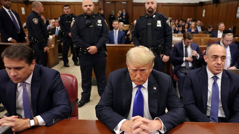 Former President Donald Trump, center, appears at Manhattan criminal court...