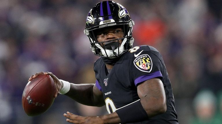 BALTIMORE, MARYLAND - DECEMBER 12: Quarterback Lamar Jackson #8 of...