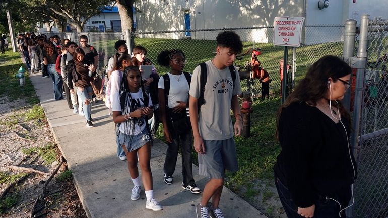 Students line up outside Hollywood Hills High School in Hollywood,...