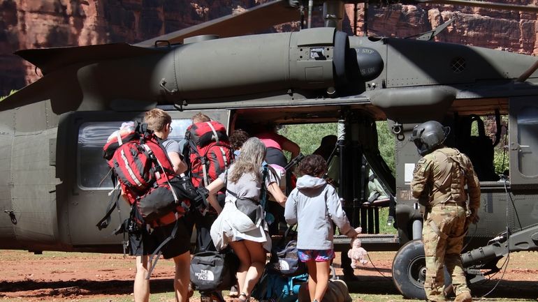 U.S. Army soldiers of the Arizona National Guard guide tourists...