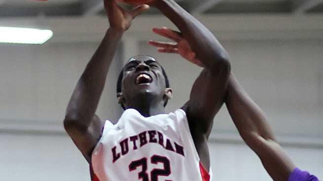 Long Island Lutheran's Kentan Facey attempts a layup from under...