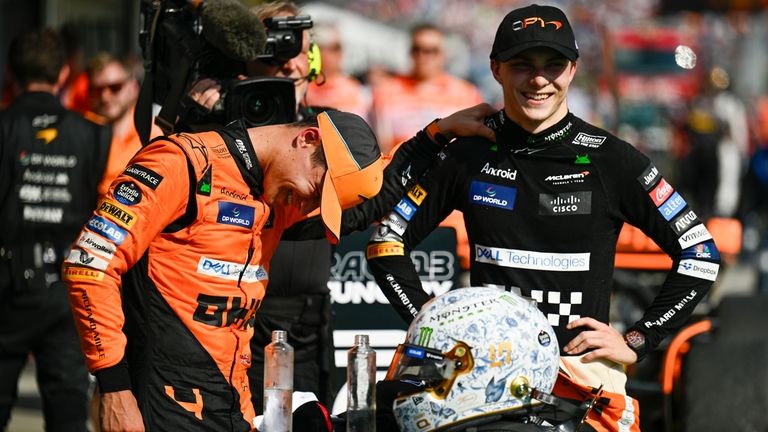 McLaren driver Lando Norris of Britain, left, congratulates McLaren driver...