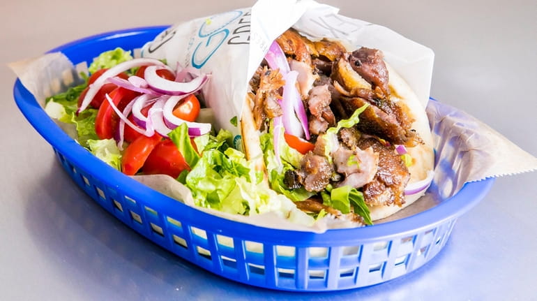 Pork Gyro Pita with lettuce, tomato and onion on side...