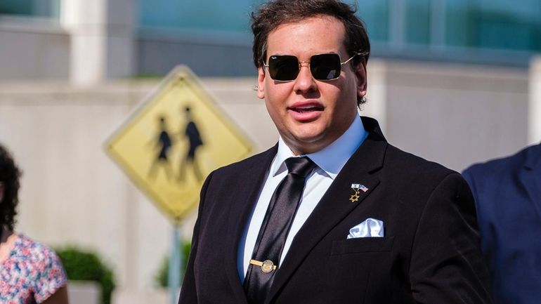 Expelled former Rep. George Santos leaves the federal courthouse in...