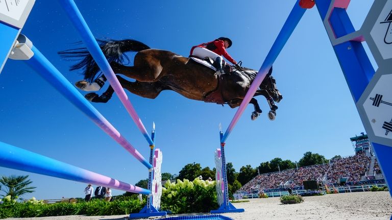 USA's Laura Kraut, riding Baloutinue, during the Equestrian Jumping qualifiers,...