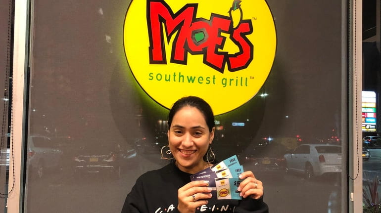 Newsday reporter Daysi Calavia-Robertson shows off coupons she won for...