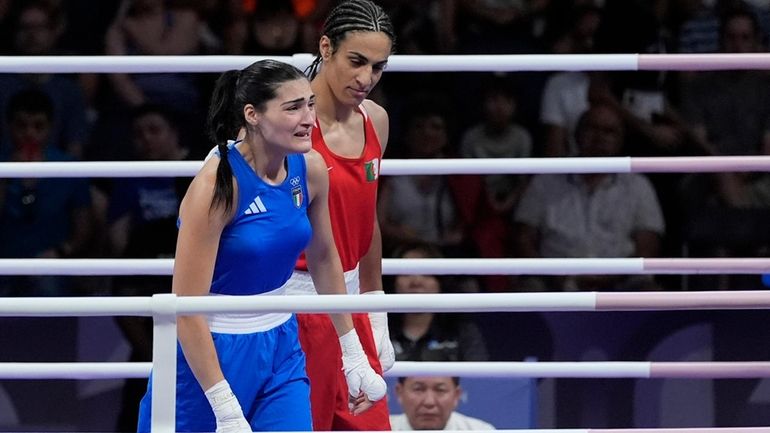 Algeria's Imane Khelif, right, defeated, Italy's Angela Carini in their...