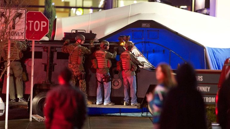 SWAT team members wait outside the Clackamas Town Center.