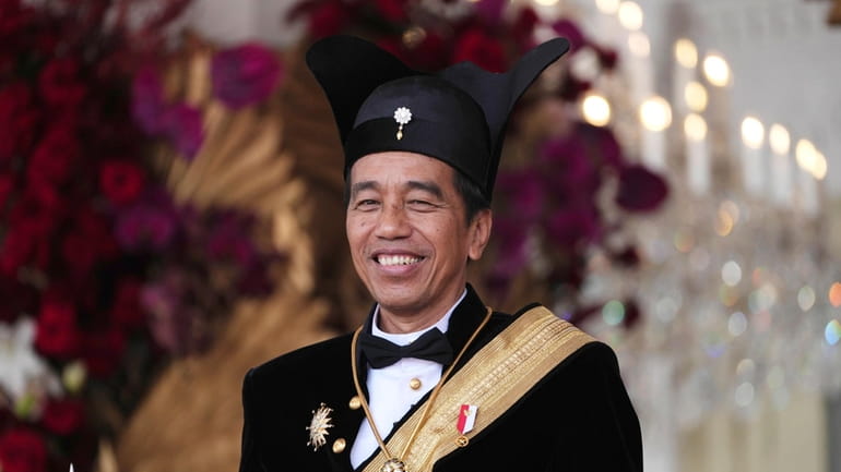 Indonesian President Joko Widodo, dressed in traditional Central Javanese royalty...