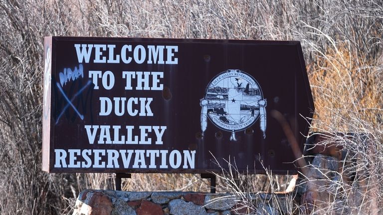 The Duck Valley Indian Reservation sign stands on March 15,...