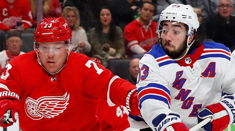 Detroit Red Wings left wing Adam Erne and Rangers center Mika...