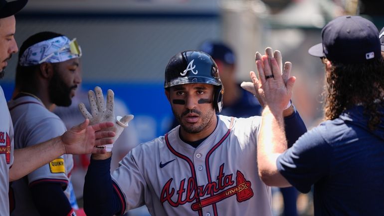 Atlanta Braves' Ramon Laureano celebrates after hitting a solo-home run...