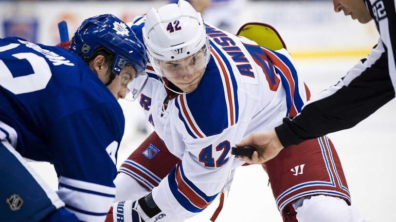Artem Anisimov faces off against Toronto Maple Leafs player Tyler...