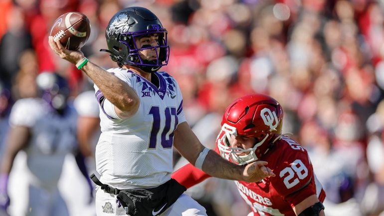 TCU quarterback Josh Hoover (10) passes under pressure by Oklahoma...