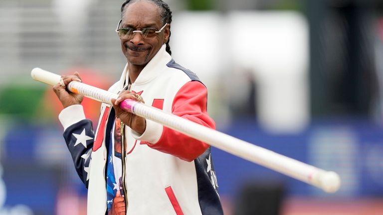 Snoop Dogg gets a pole vaulting lesson during the U.S....