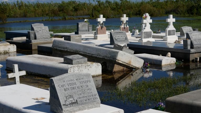 Tombs are seen after being disturbed by flooding, in the...