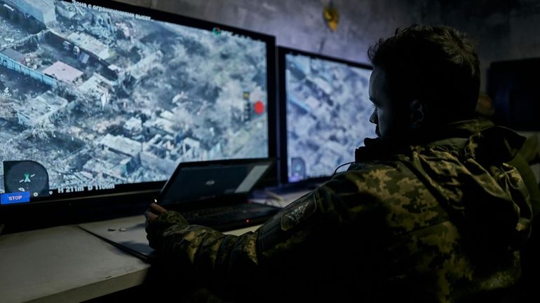 A Ukrainian soldier watches a drone feed from an underground...