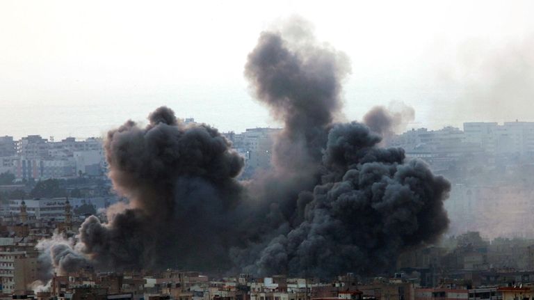 An Israeli air strike hits a residential area that is...