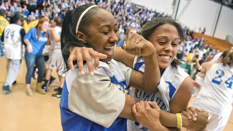 Riverhead players Naysha Trent, center, and Melodee Riley, right, celebrate...