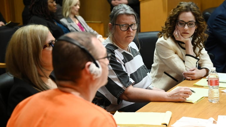 Jennifer Crumbley stares at her husband James Crumbley during sentencing...