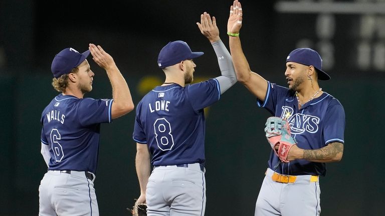 Tampa Bay Rays' Taylor Walls (6) celebrates with Brandon Lowe...