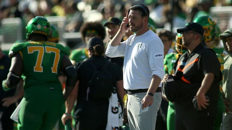 Oregon head coach Dan Lanning watches the first half of...