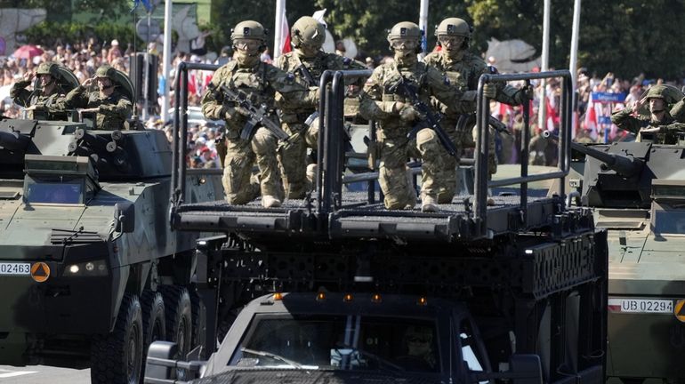 Polish troops take part in a massive military parade to...