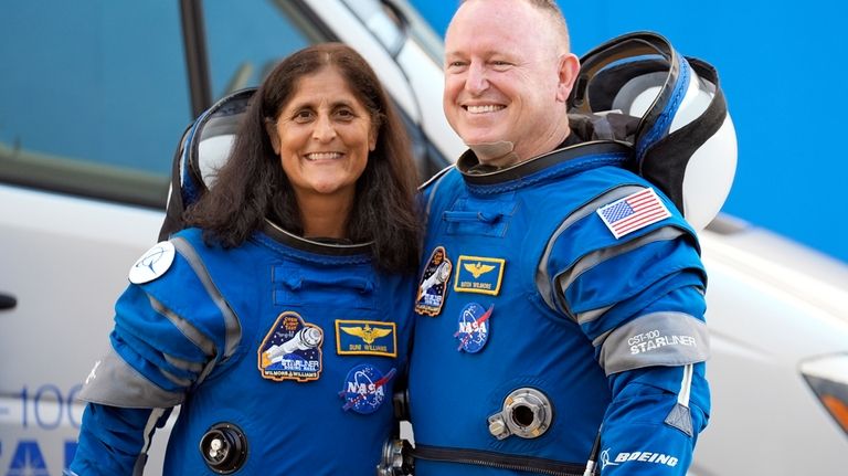 NASA astronauts Suni Williams, left, and Butch Wilmore stand together...