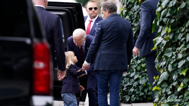 President Joe Biden, center, talks to his grandson Beau, left,...