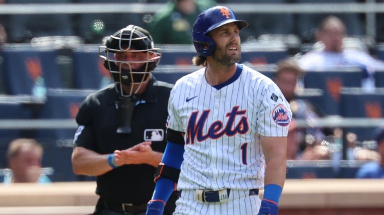 The Mets' Jeff McNeil strikes out in the ninth inning...