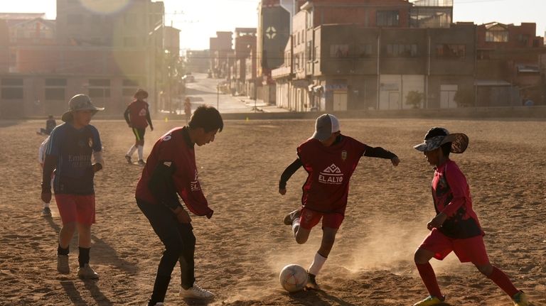 Children play soccer near the Municipal Villa Ingenio stadium in...