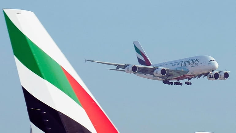 An Emirates Airbus A380 jumbo jet lands at Dubai International...