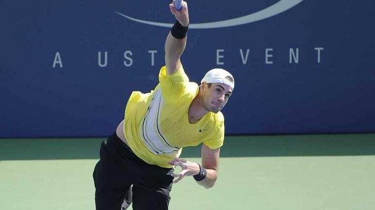 John Isner of the USA serves to Robby Ginepri of...