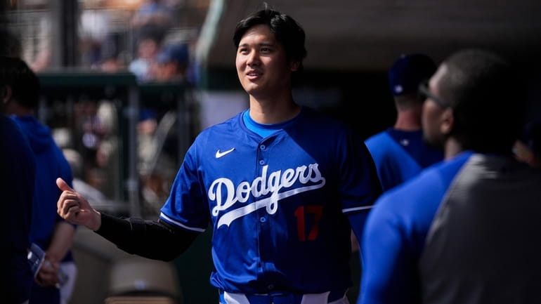 Los Angeles Dodgers designated hitter Shohei Ohtani walks in the...
