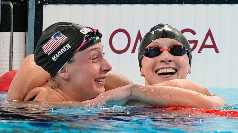 United States' Katie Ledecky celebrates with teammate Paige Madden after...