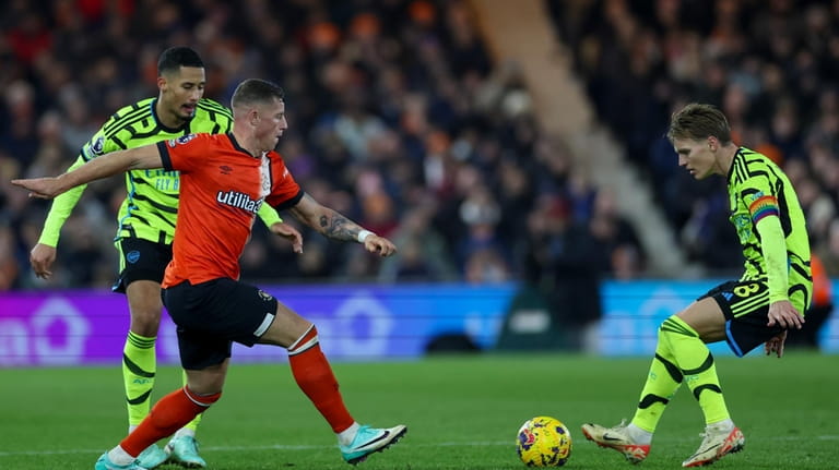 Luton Town's Ross Barkley, left, duels for the ball with...