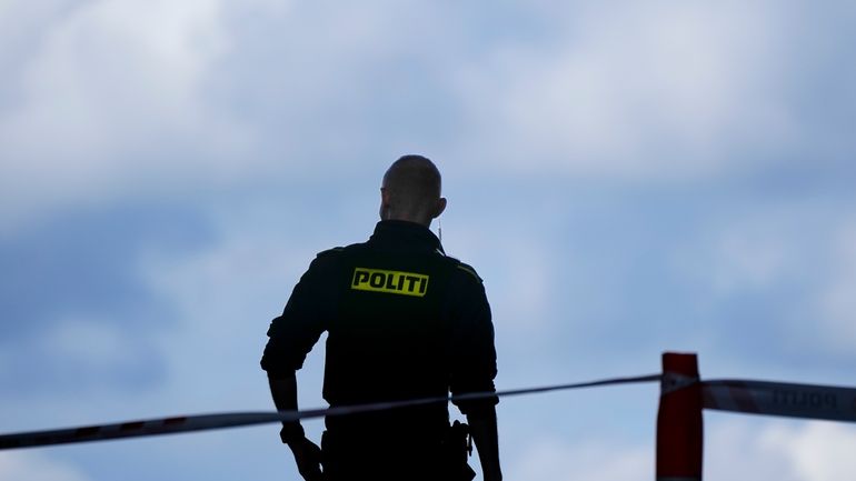 A police officer stands guard in Copenhagen, Denmark, on July...