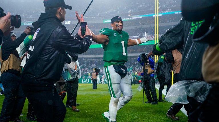 Philadelphia Eagles quarterback Jalen Hurts celebrates after scoring the game...