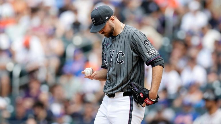 Tylor Megill of the Mets stands on the mound during...