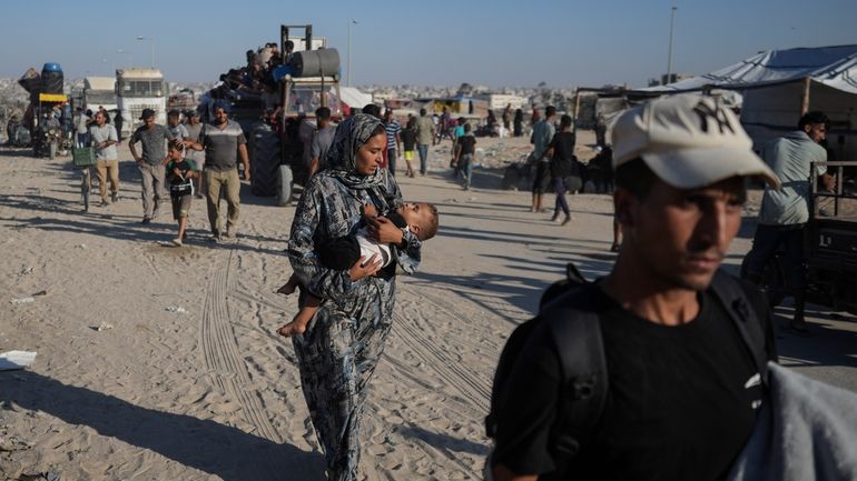 Palestinians flee the Khan Younis area of the Gaza Strip,...