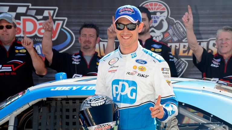 Joey Logan poses with the pole award in victory lane...