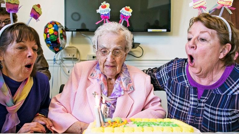 Sister Grace Regina Wingenfeld, center, celebrates her 106th birthday on...