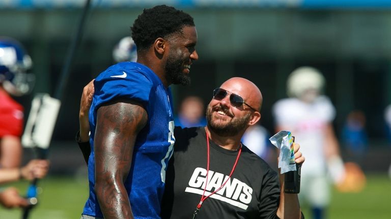 Giants linebacker Brian Burns and head coach Brian Daboll during...