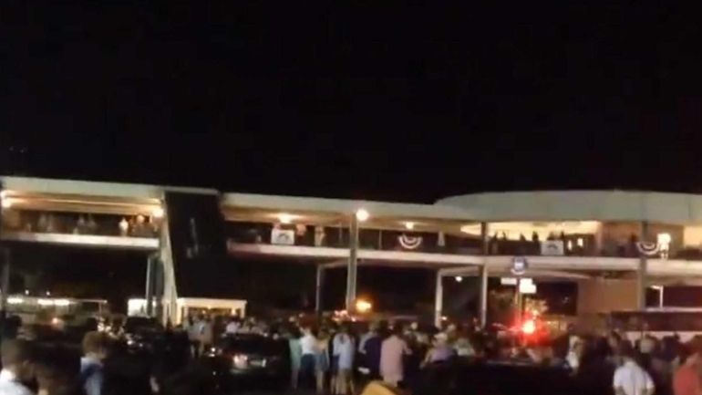 Patrons wait to board the train at the Belmont Park...