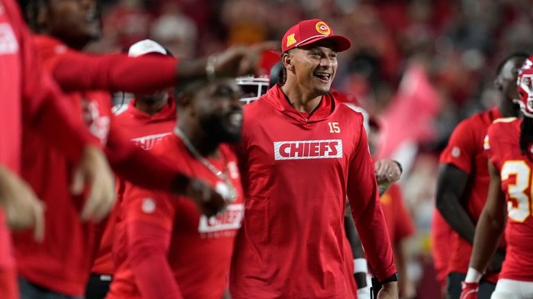 Kansas City Chiefs quarterback Patrick Mahomes celebrates on the sidelines...