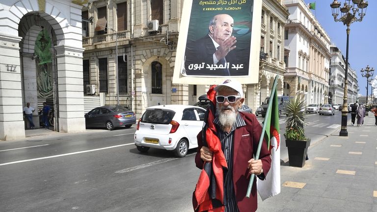 A supporter of Algerian President and candidate for reelection Abdelmadjid...