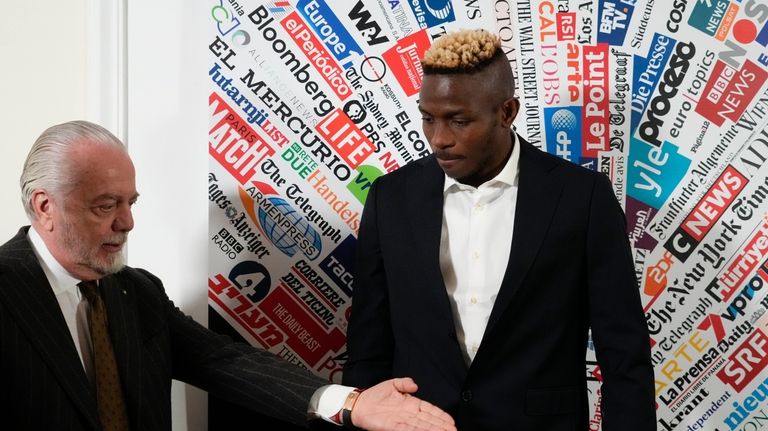 SS Napoli striker Victor Osimhen, right, arrives with team President...